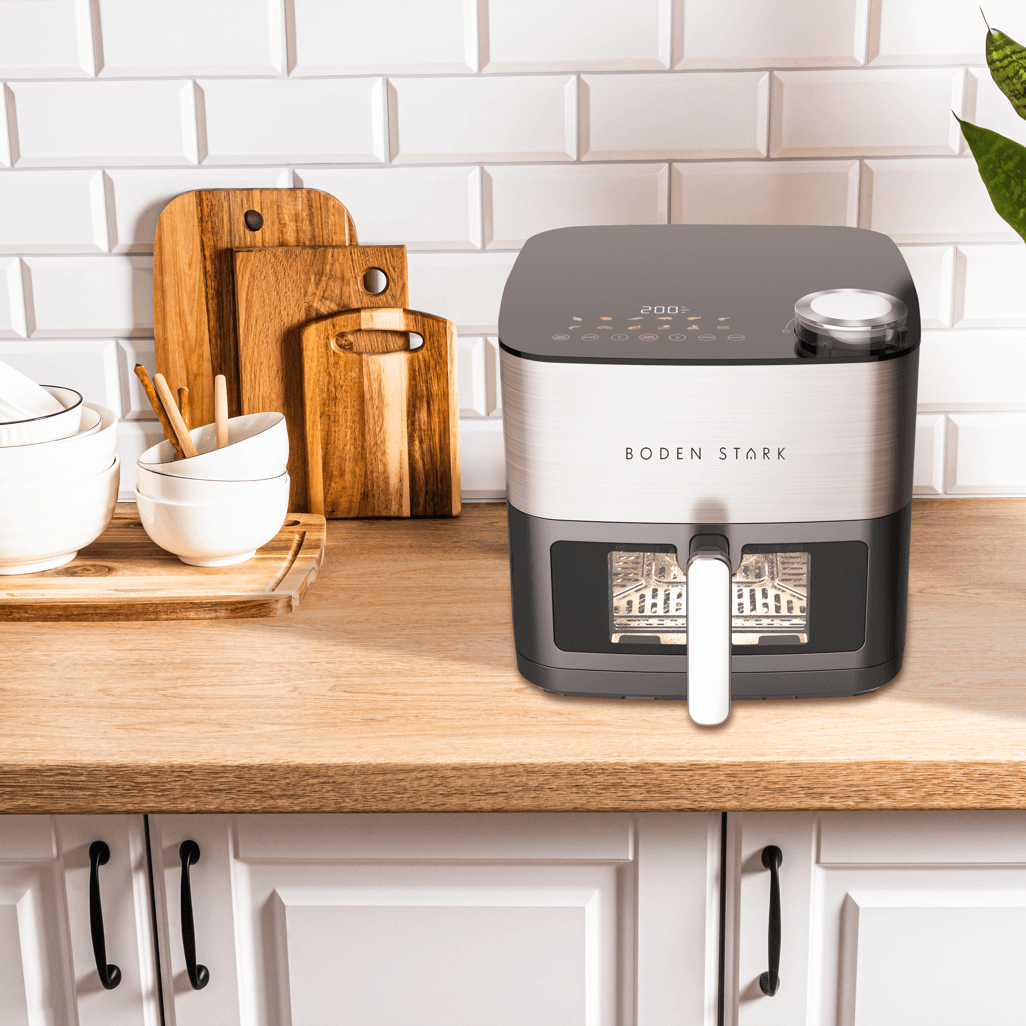 Boden Stark 8L Dual Element Air Fryer with Steaming Function on kitchen countertop with bowls and cutting boards.