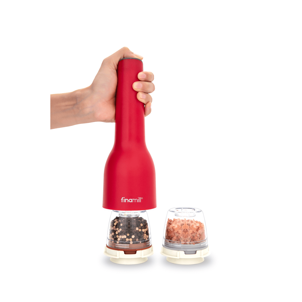 FINAMILL rechargeable grinder in Sangria color, held in hand, with spice containers in view.