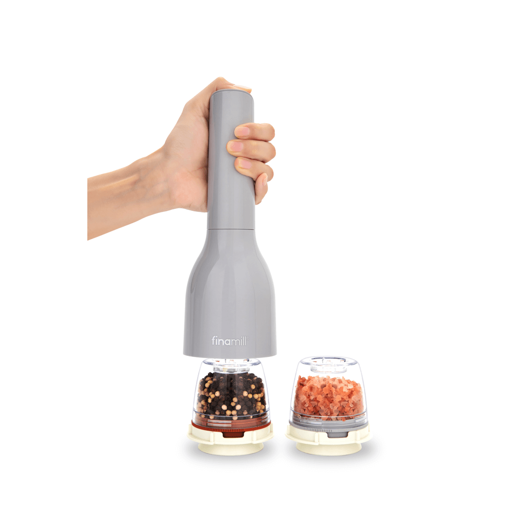 FINAMILL battery operated stone grinder with a hand holding it, featuring spice containers on the side.