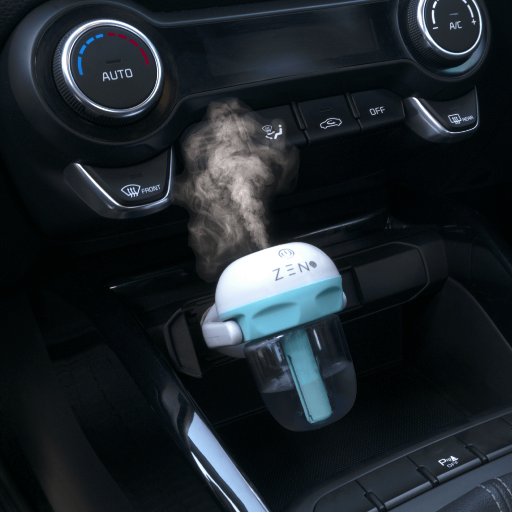 ZEN Serenity Mini Car Diffuser in blue releasing calming mist, designed for enhanced air freshness in vehicles.