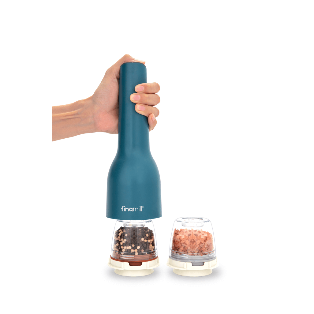FINAMILL rechargeable grinder in ocean blue, held by a hand, with spice containers beside it.