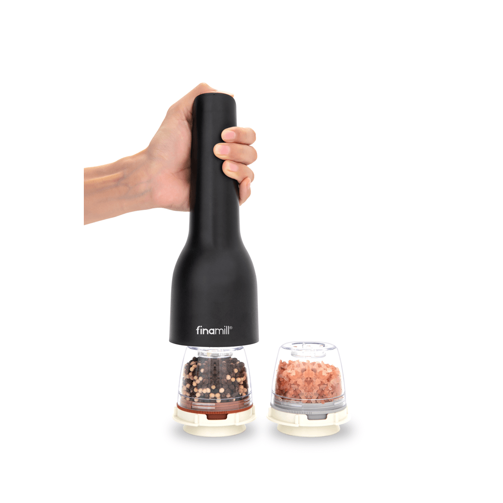 Hand holding FINAMILL RECHARGEABLE grinder in Midnight Black with spice containers on the side.