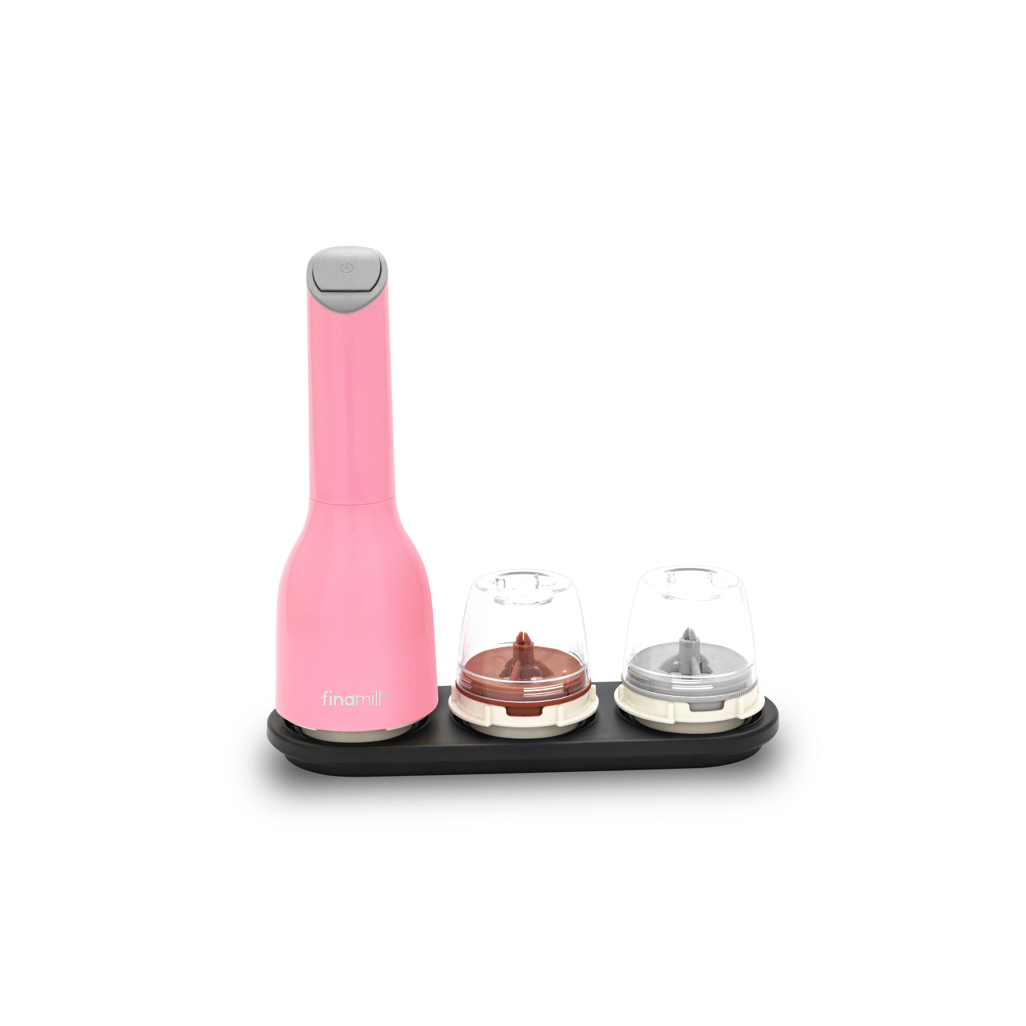 FINAMILL pink battery-operated grinder with two interchangeable grinders on a black base.