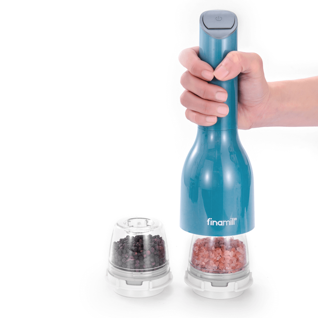 FINAMILL battery-operated grinder in Ocean Blue held by hand, with containers of black and pink salt.