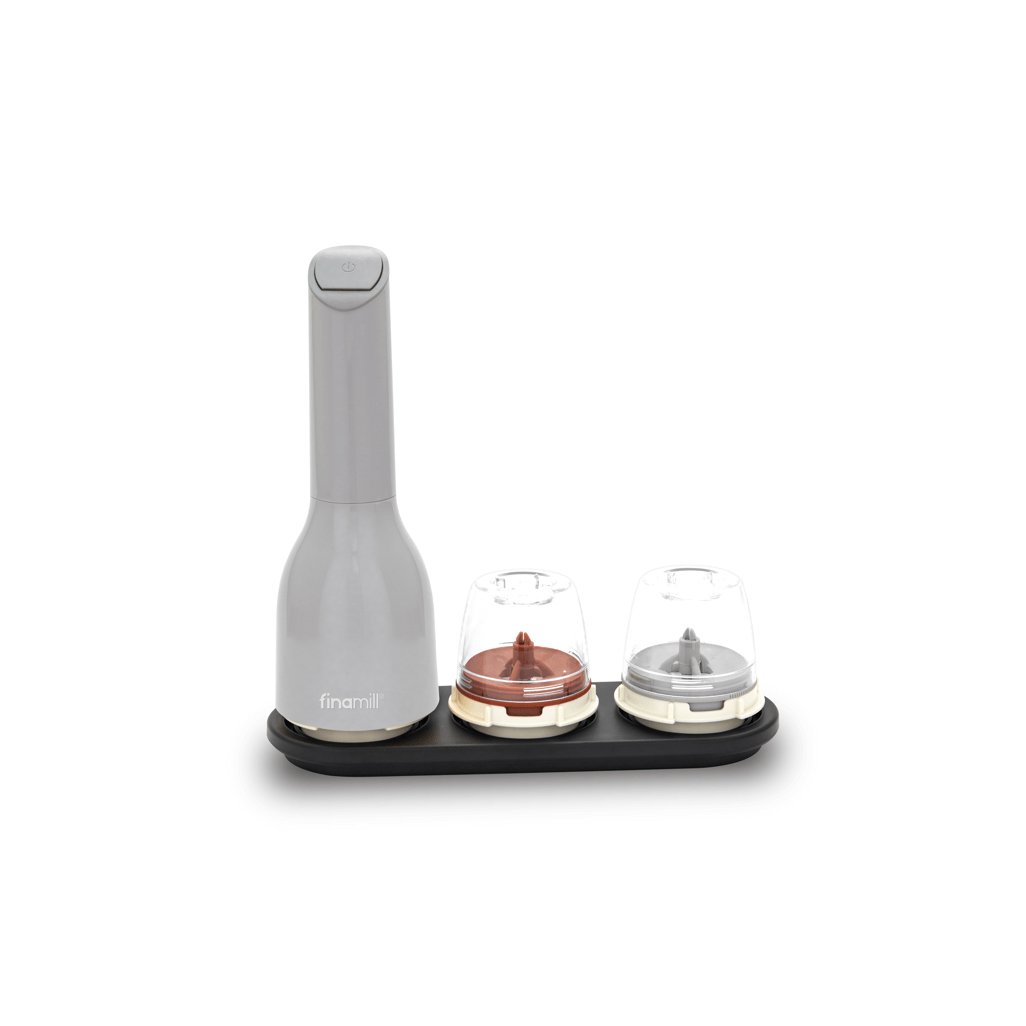 FINAMILL battery-operated grinder in gray with two grinding chambers on a black base for versatile spice grinding.
