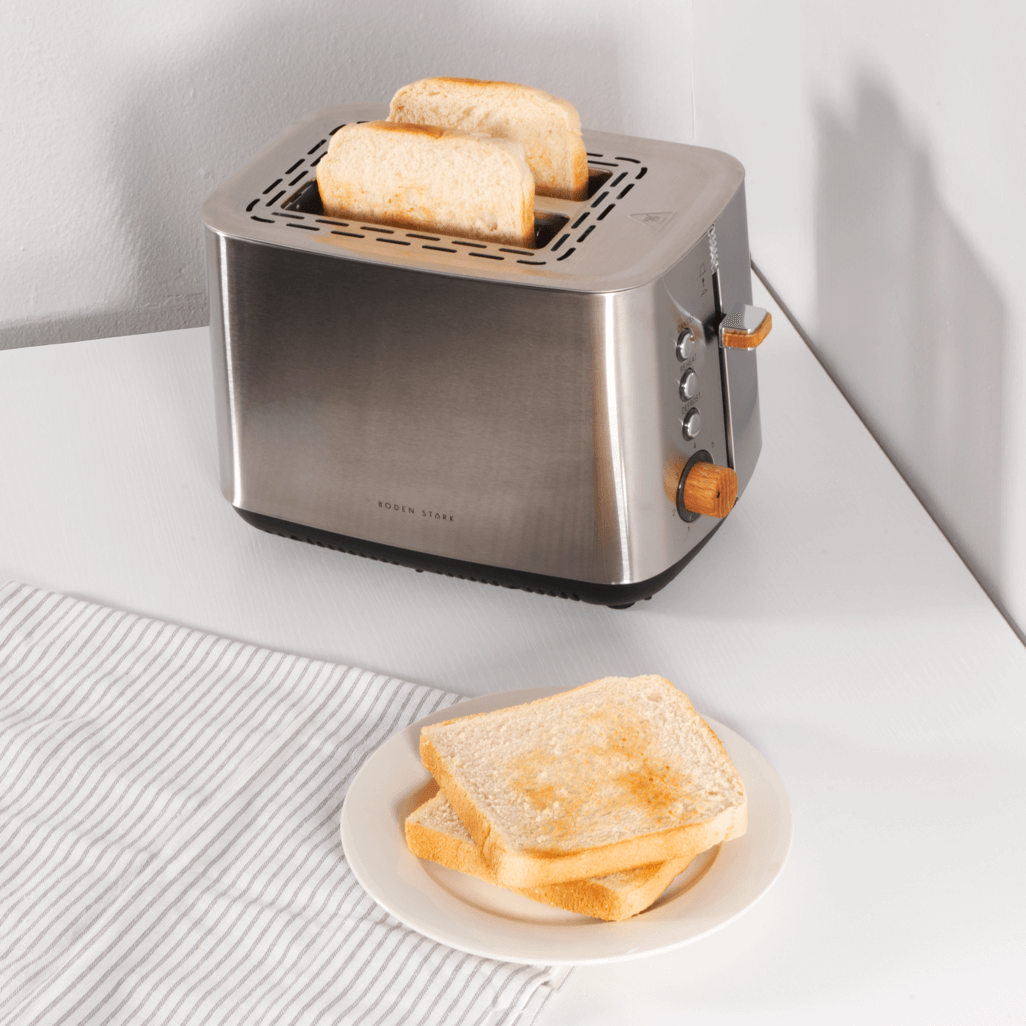 Boden Stark Anson Collection 2 slice stainless steel toaster with toasted bread on a plate, showcasing elegant design.
