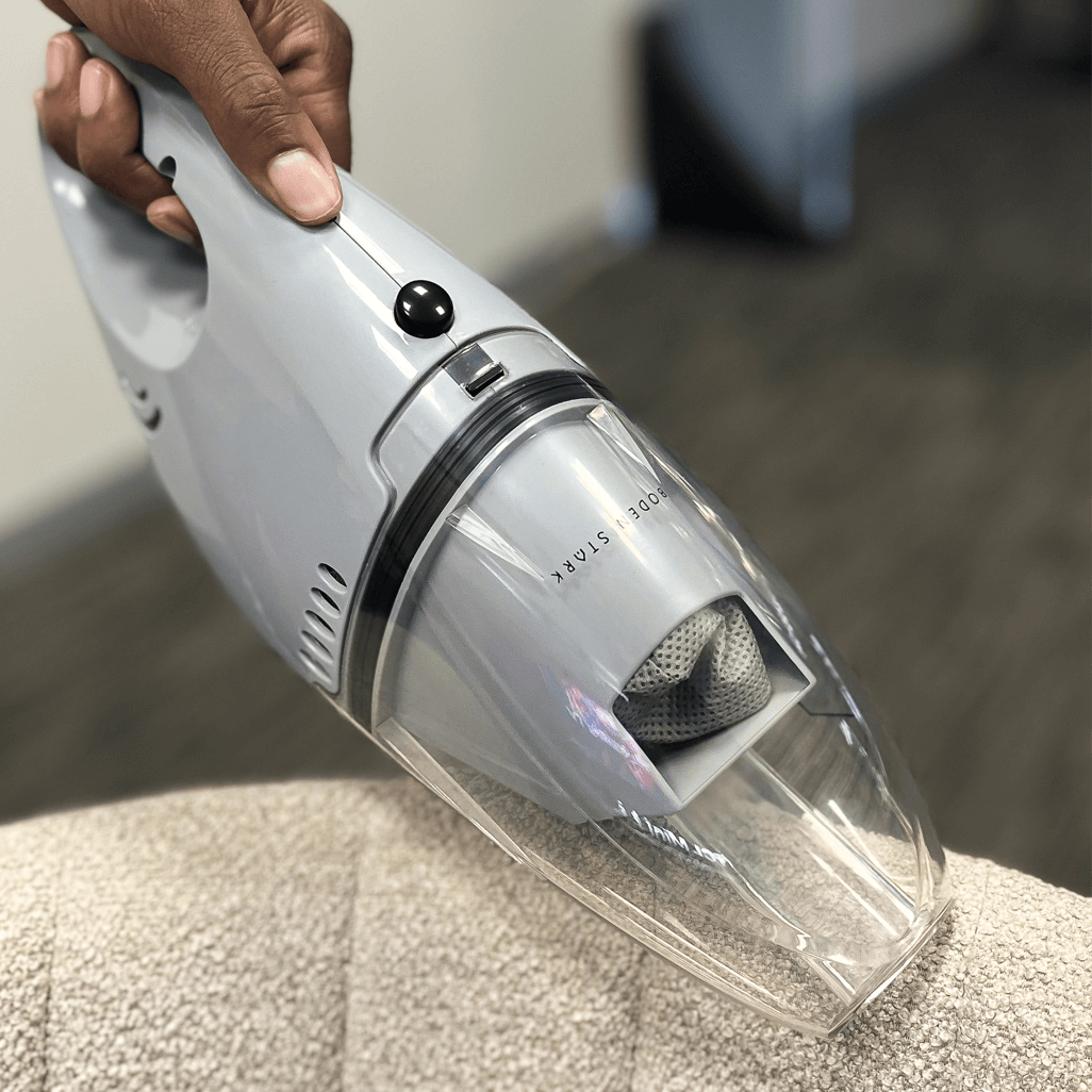 Boden Stark Wet & Dry Handheld Vacuum Cleaner in use, featuring sleek design for efficient cleaning of surfaces.