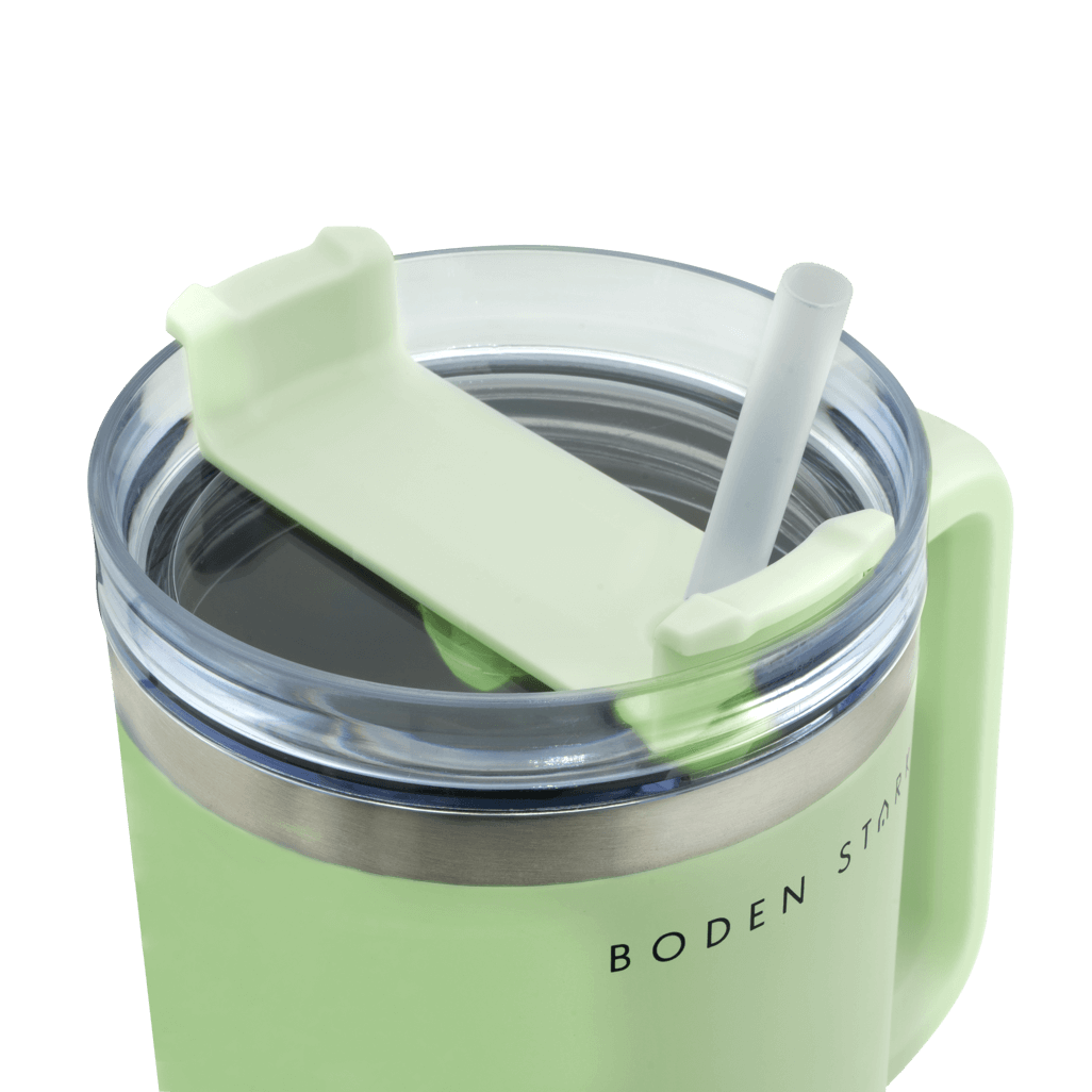 Close-up of Boden Stark 1200ml Travel Mug in green with lid and straw, perfect for travel and outdoor use.