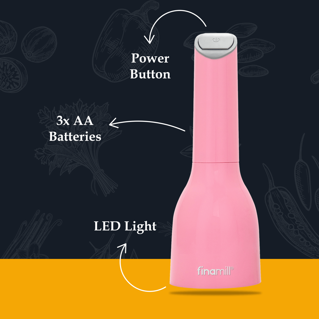 FINAMILL battery-operated grinder in pink, featuring power button, LED light, and 3x AA battery compartment.