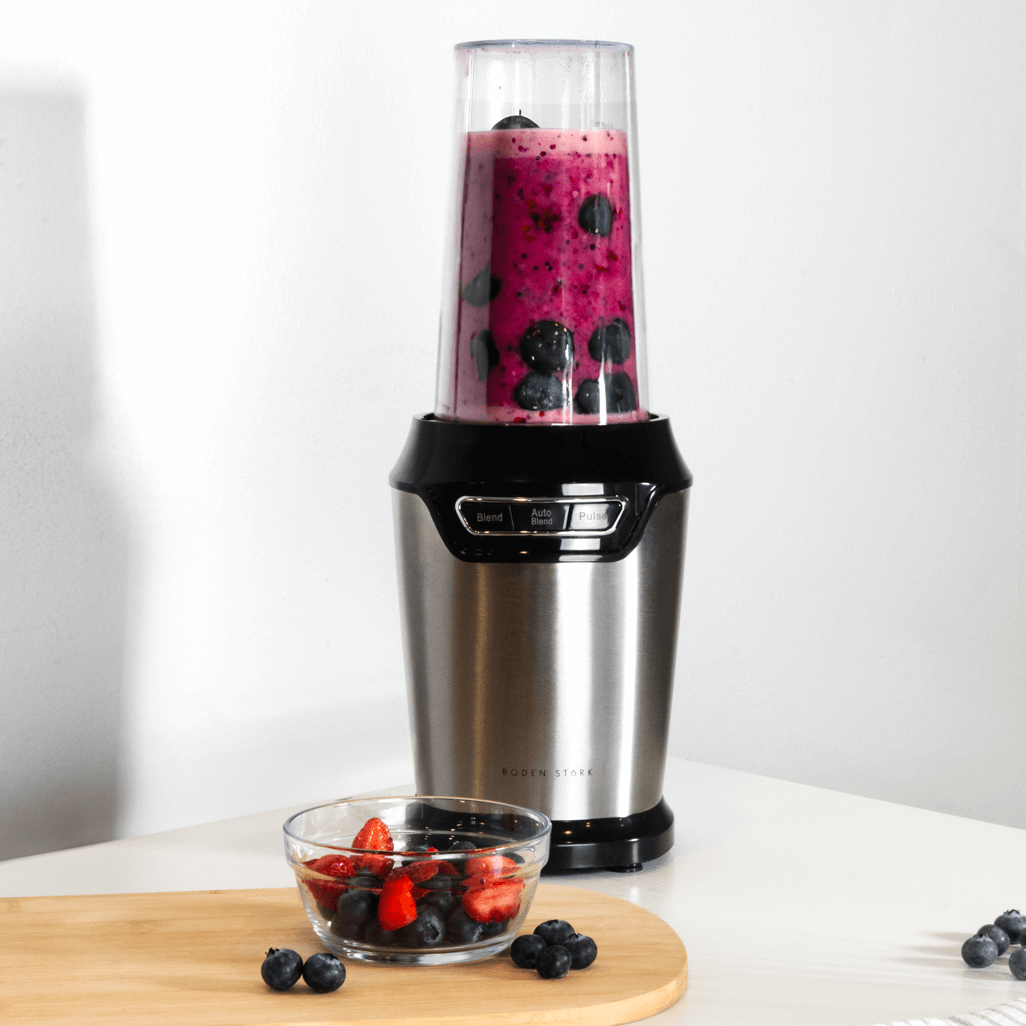 Boden Stark 1000W Nutri Blender preparing a berry smoothie with fresh blueberries and strawberries.