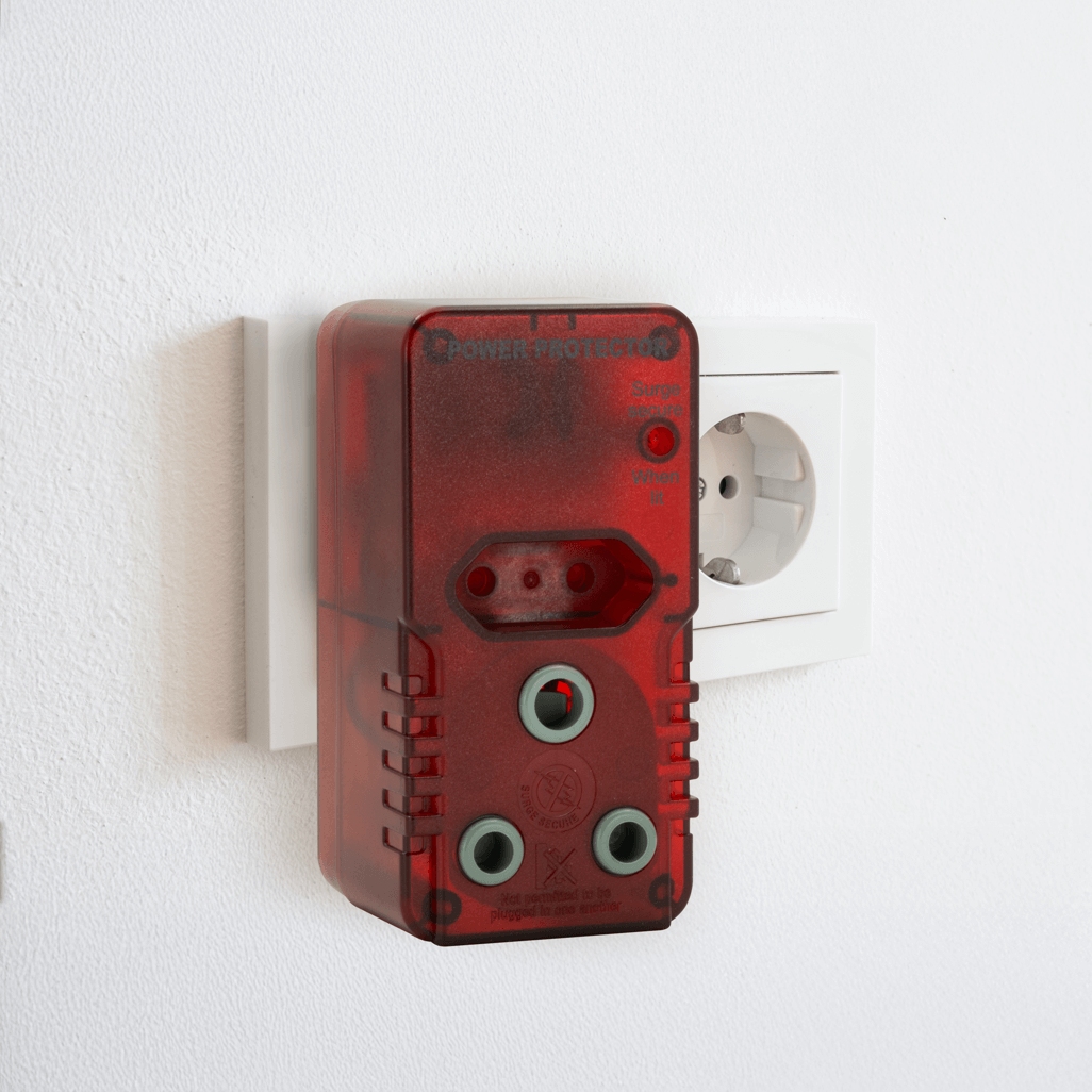 Ellies High Surge Adaptor plugged into a wall socket, featuring 1x 5A Euro and 1x 16A 3-pin outputs.