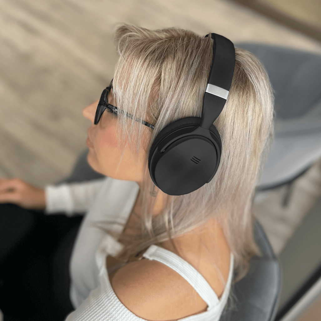 Woman wearing VolkanoX Silenco series active noise cancelling Bluetooth headphones in black.