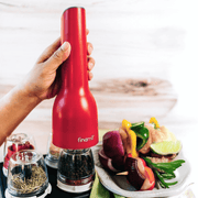 FINAMILL rechargeable grinder in Sangria color, used for grinding spices, with fresh vegetables on a plate.