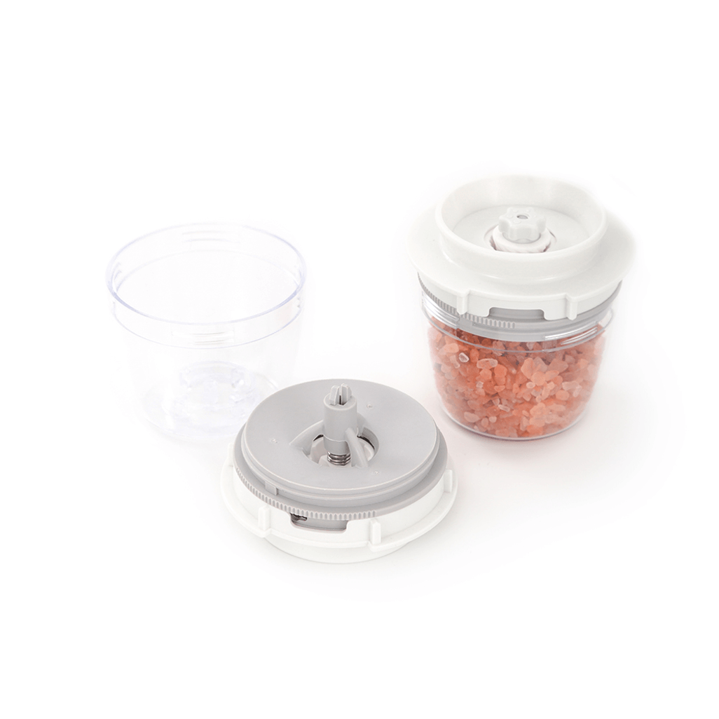 FinaPod Pro Plus salt grinder with transparent container and pink Himalayan salt, ideal for seasoning meals.