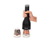FINAMILL battery operated grinder in Midnight Black, held in hand with spice containers ready for use.