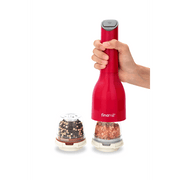 FINAMILL battery operated grinder in Sangria color, designed for grinding spices, held in hand with spice containers next to it.