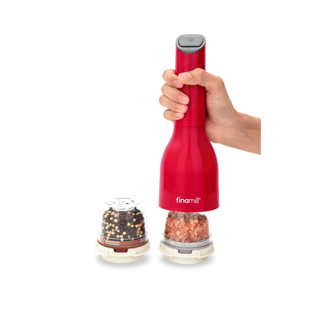 FINAMILL battery operated grinder in Sangria color, designed for grinding spices, held in hand with spice containers next to it.