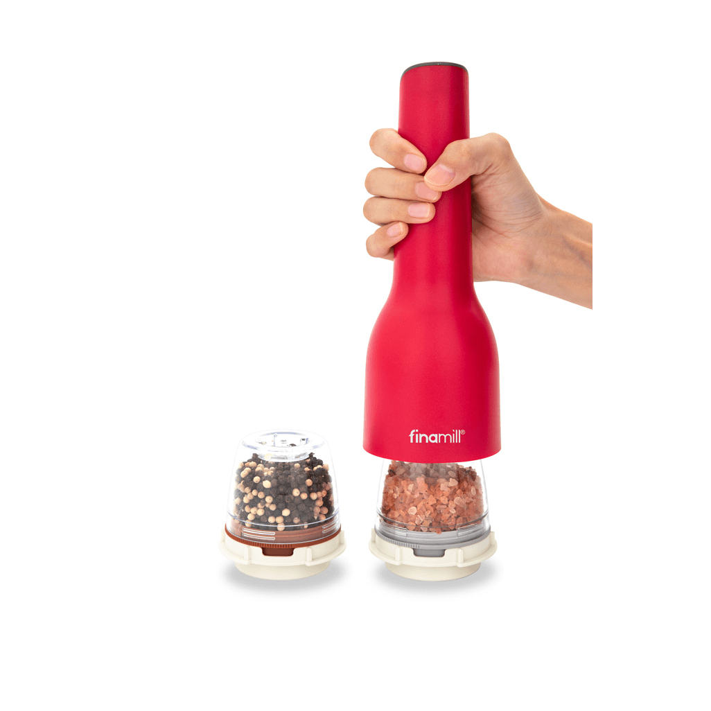 FINAMILL Rechargeable grinder in Sangria color, held by hand, next to spice containers for versatile seasoning.