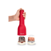 FINAMILL rechargeable grinder in Sangria color, held in hand, with spice containers in view.