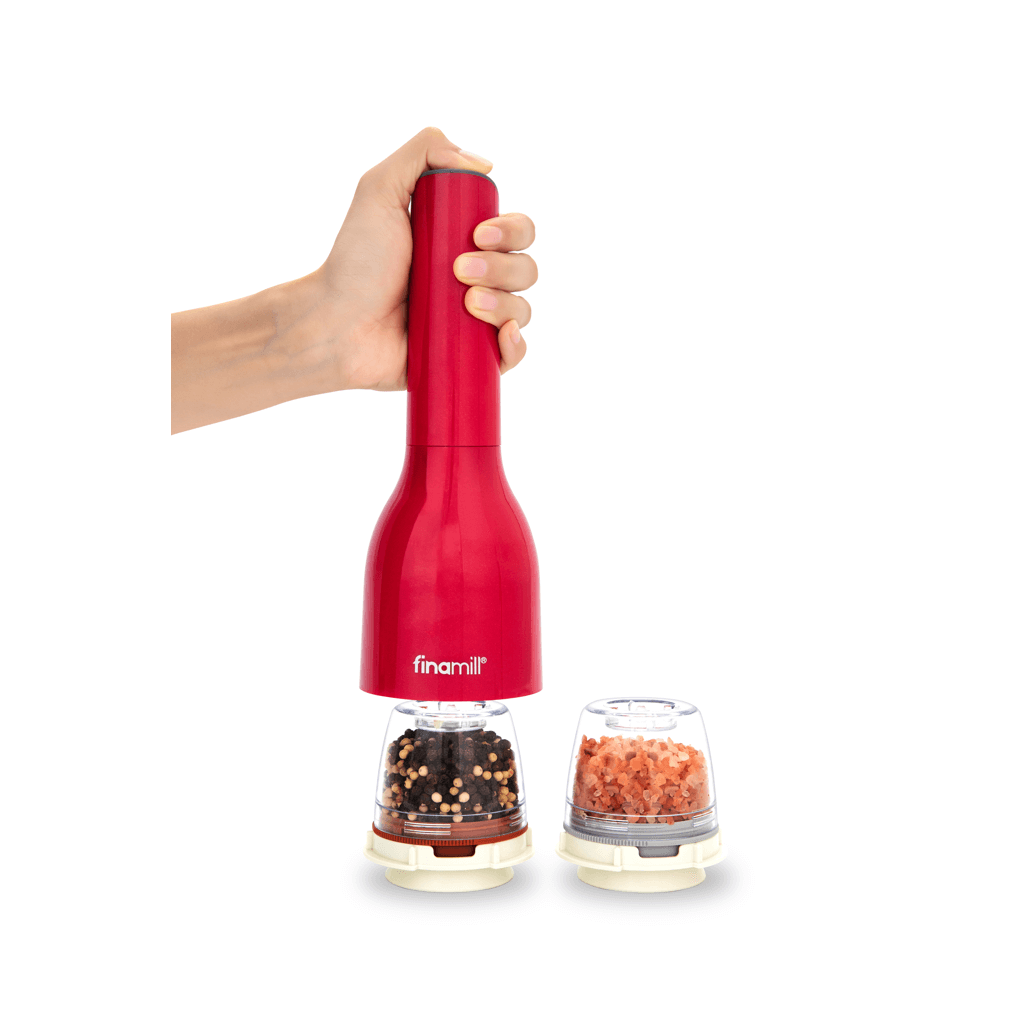 FINAMILL battery-operated grinder in Sangria color, hand holding the grinder over spice containers.