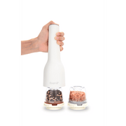 FINAMILL rechargeable grinder in soft cream, showcasing hand holding the grinder with spice containers.