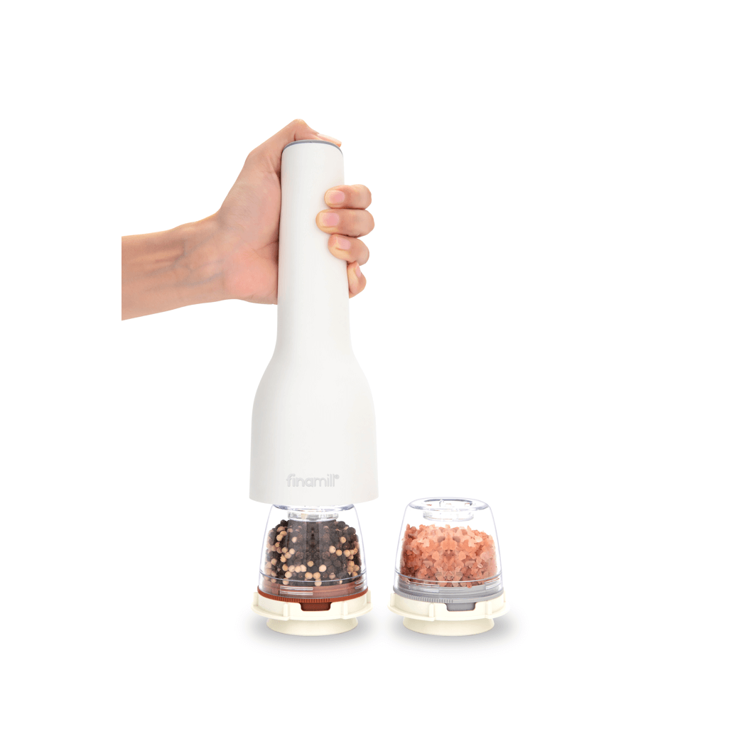 FINAMILL rechargeable grinder in soft cream, showcasing hand holding the grinder with spice containers.