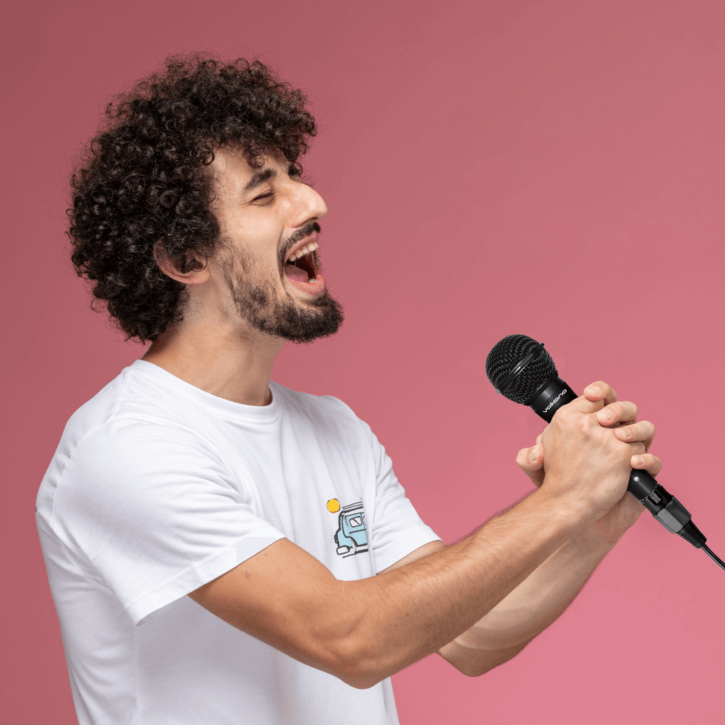 Dynamic vocalist passionately performing with the Volkano Ace series wired microphone, perfect for high-energy performances.
