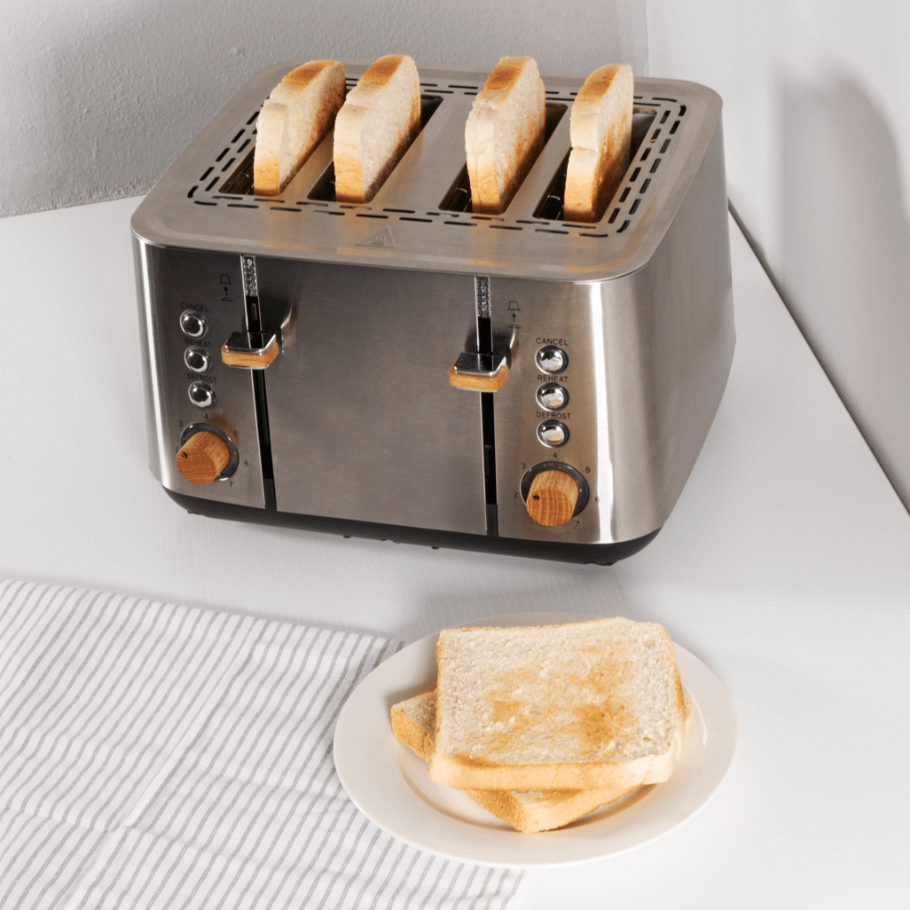 Boden Stark Anson Collection 4 Slice SS Toaster with golden toast on a white plate, showcasing sleek stainless steel design.