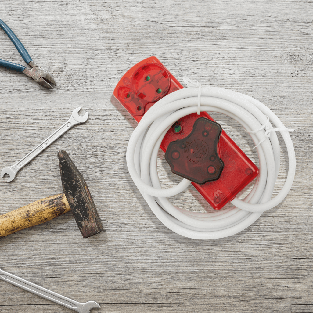Ellies 4 Way High Surge Extension Lead - 3M with tools on a wooden workbench background.