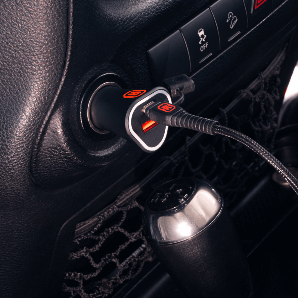 Rugged by Volkano dual USB car charger with QC3.0 and PD plugged into a vehicle's power outlet.