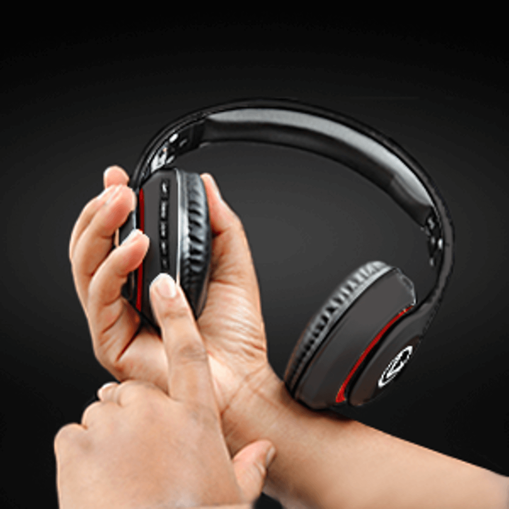 Close-up of hands adjusting the controls on Volkano Impulse Series Bluetooth headphones in black.