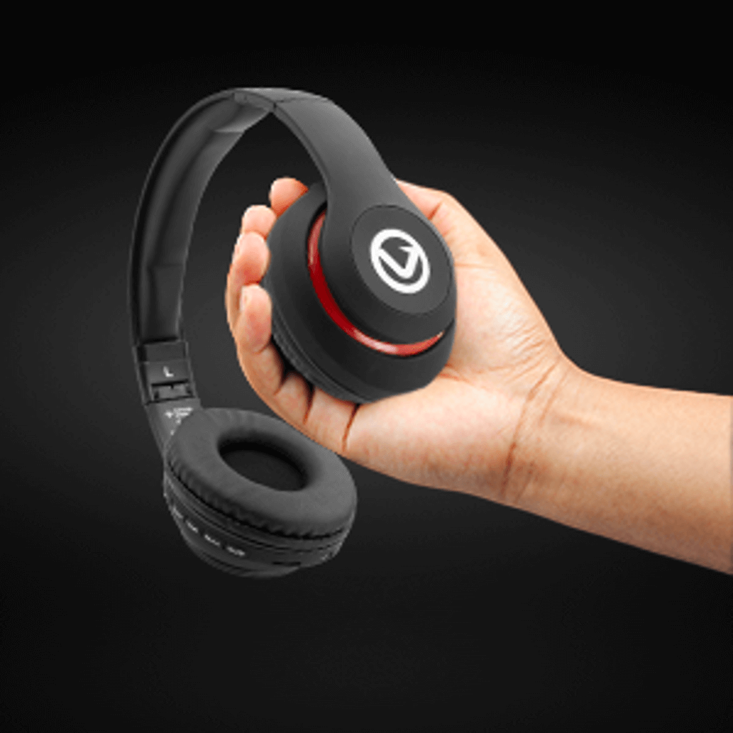Hand holding Volkano Impulse Series Bluetooth Headphones in black, showcasing their stylish design and portability.
