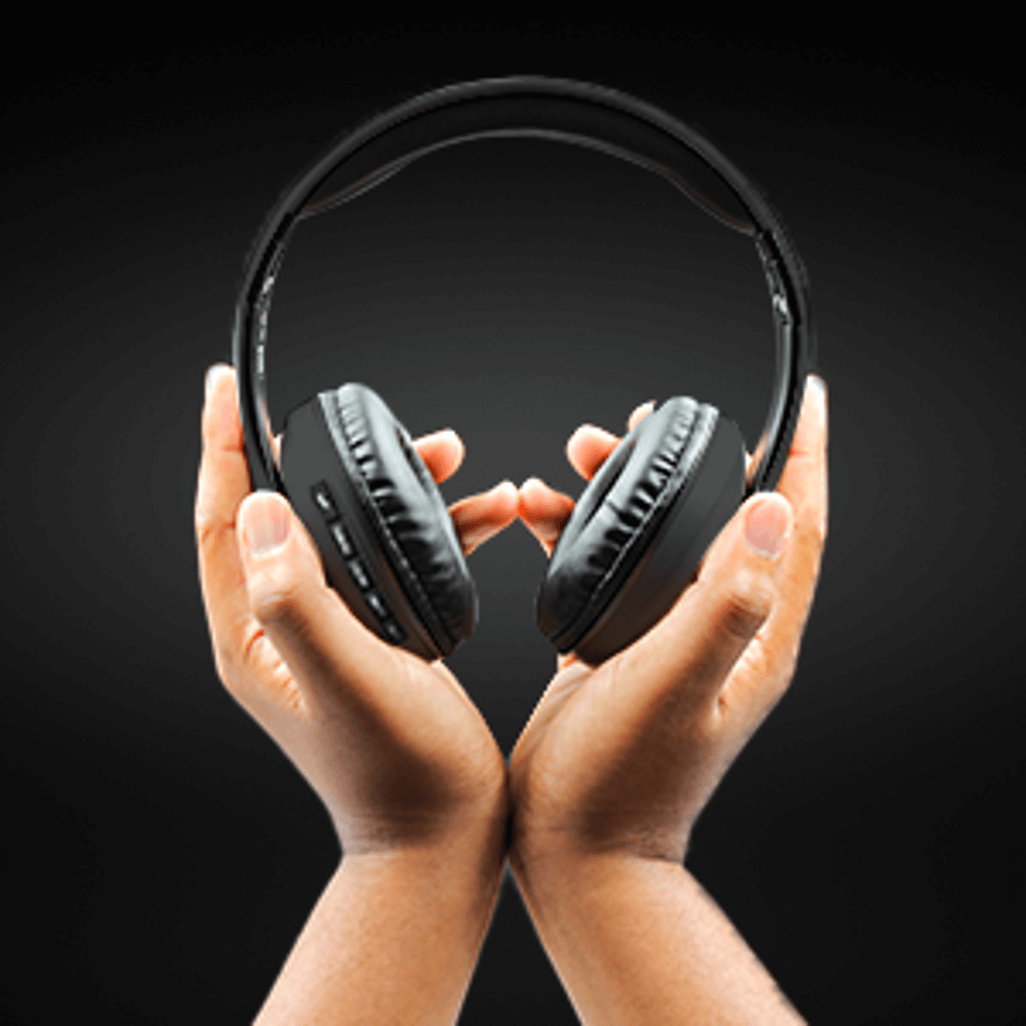 Hands holding Volkano Impulse Series Bluetooth Headphones - Black against a dark background. Perfect for organic sound lovers.