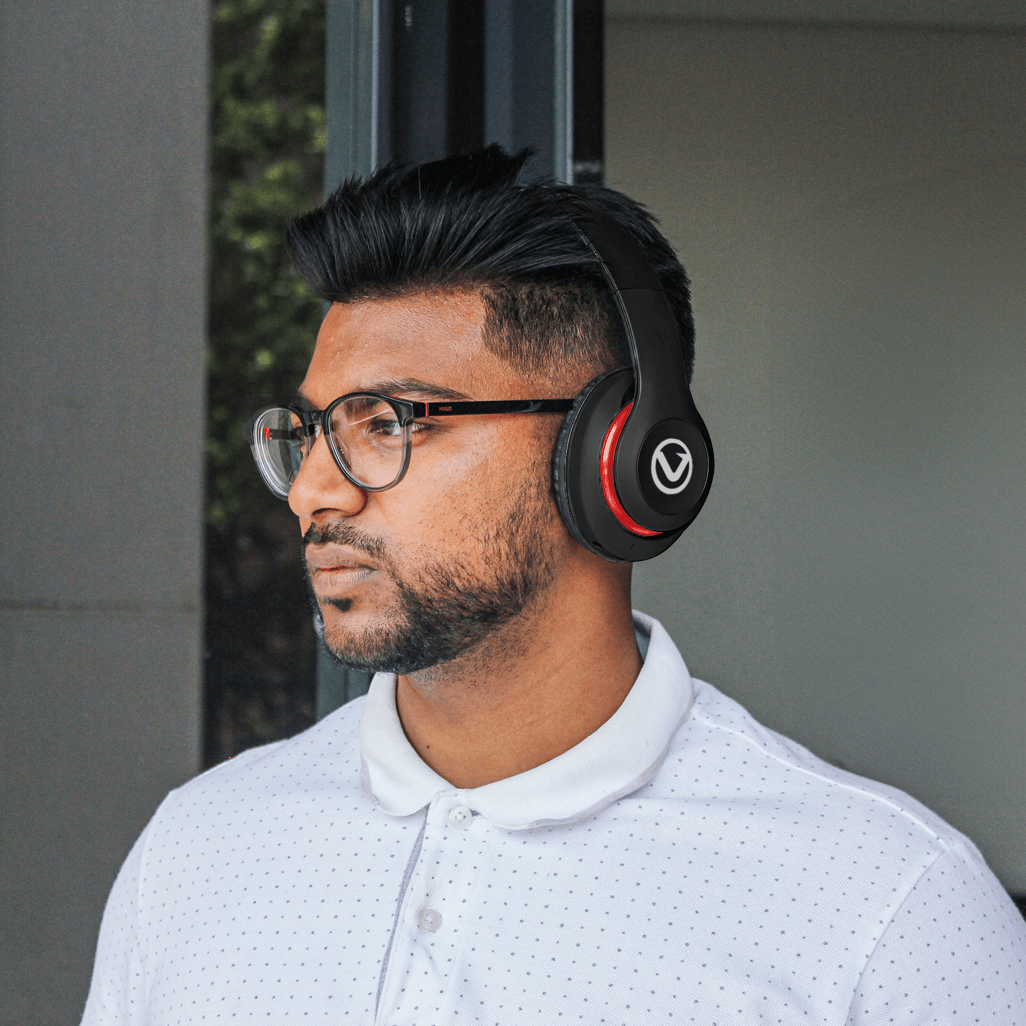 Man wearing Volkano Impulse Series Bluetooth Headphones in Black, showcasing comfort and style for an optimal listening experience.