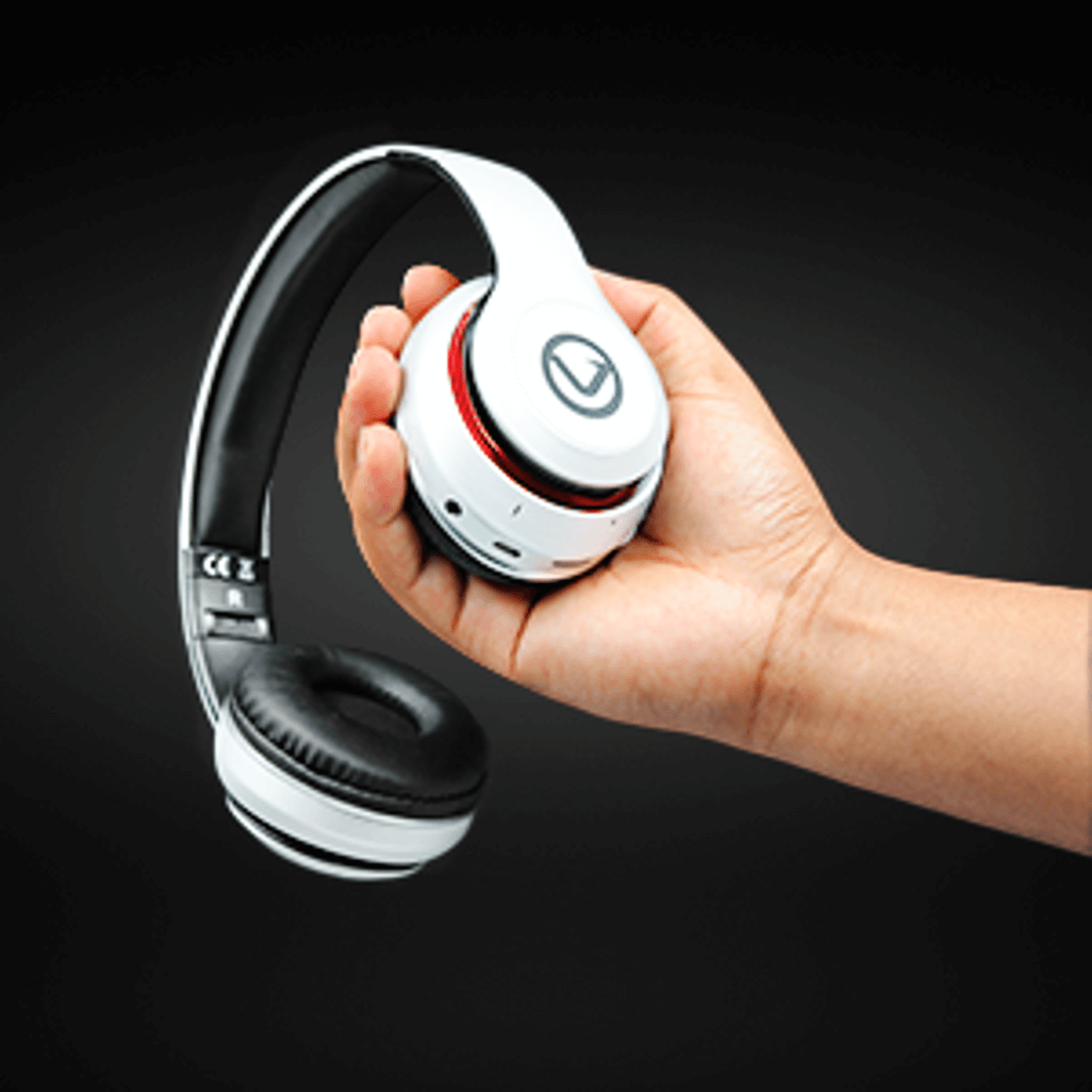 Volkano Impulse Series Bluetooth Headphones held in hand, showcasing their sleek white design and comfortable fit.
