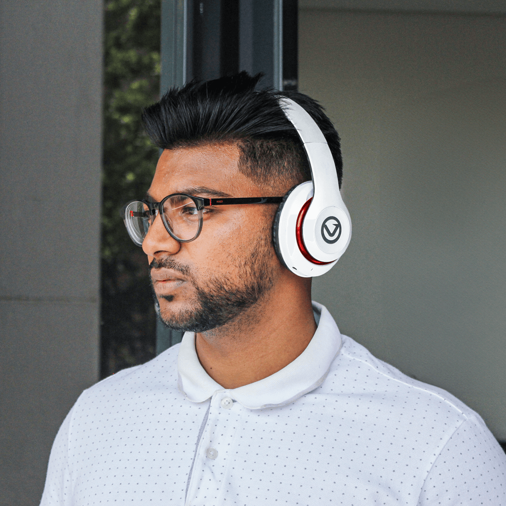 Man wearing Volkano Impulse Series Bluetooth Headphones in white, showcasing style and comfort in modern design.